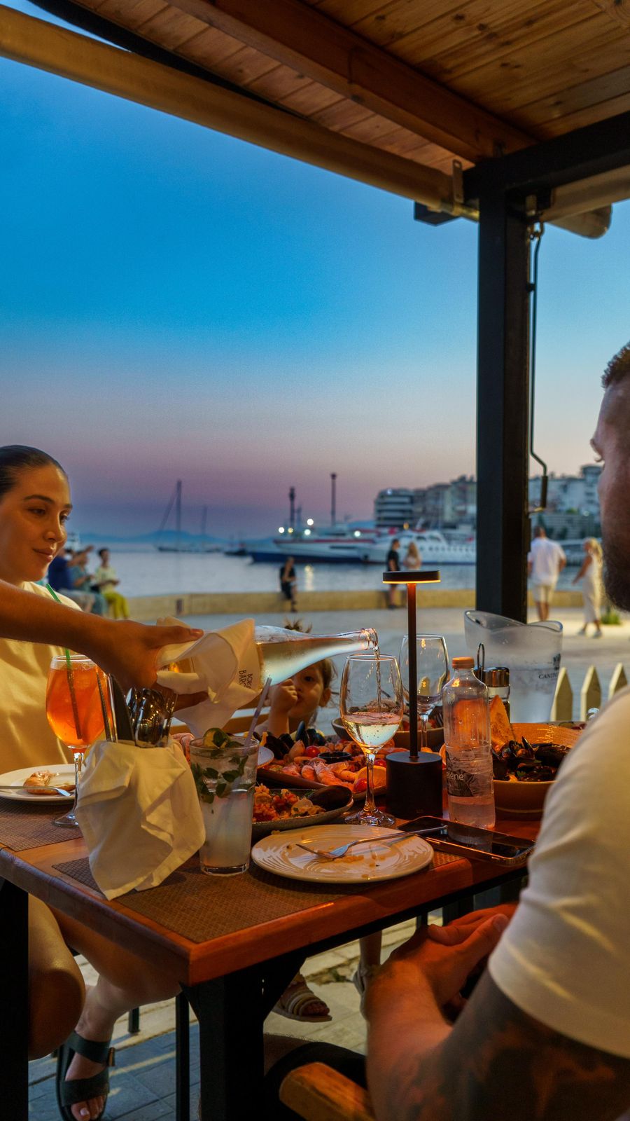 Family dining seaside during blue hour